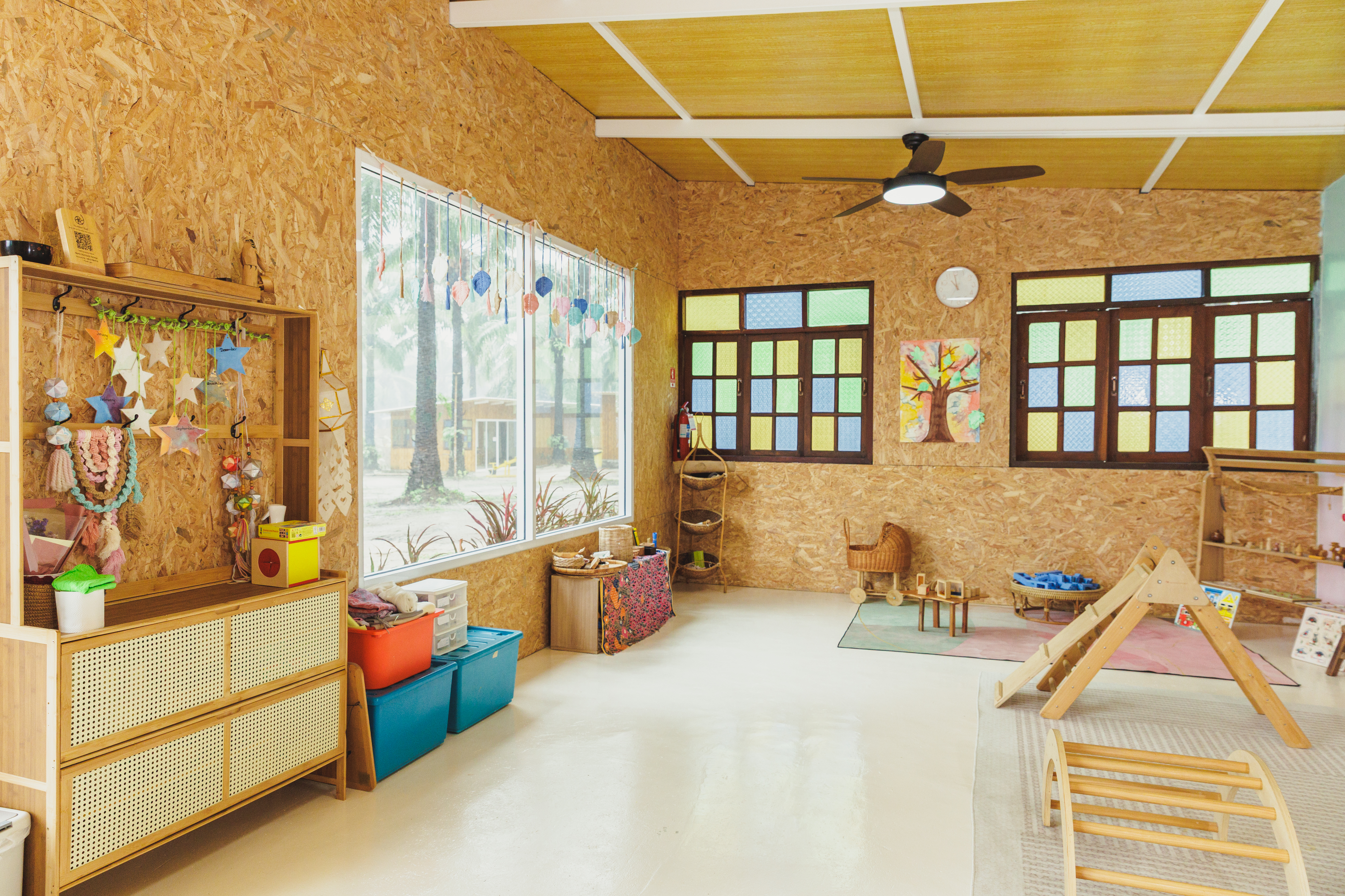Bamboo Valley classroom with nature shelf, stained glass windows, and wooden furniture