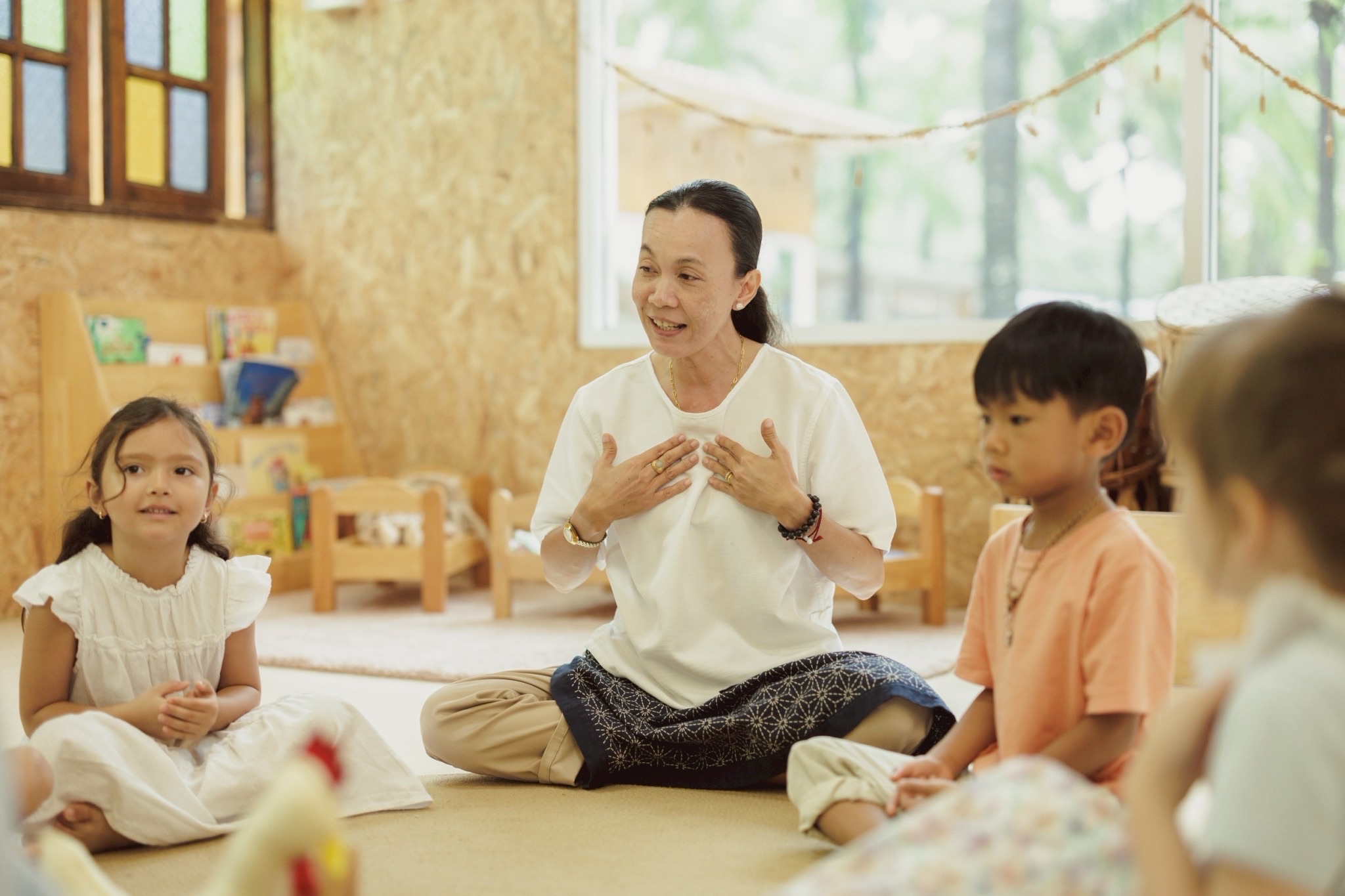 Teacher speaking to children during circle time at Bamboo Valley
